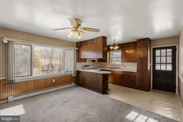 a large kitchen with a large window and stainless steel appliances