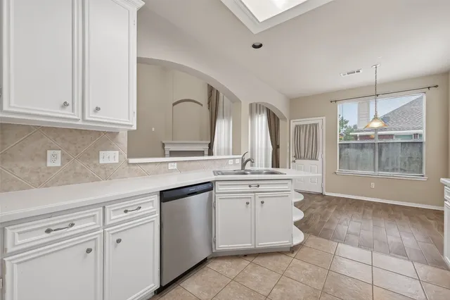 a kitchen with a sink and cabinets