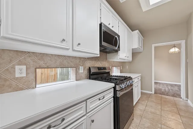 a kitchen with stainless steel appliances granite countertop a sink and a stove