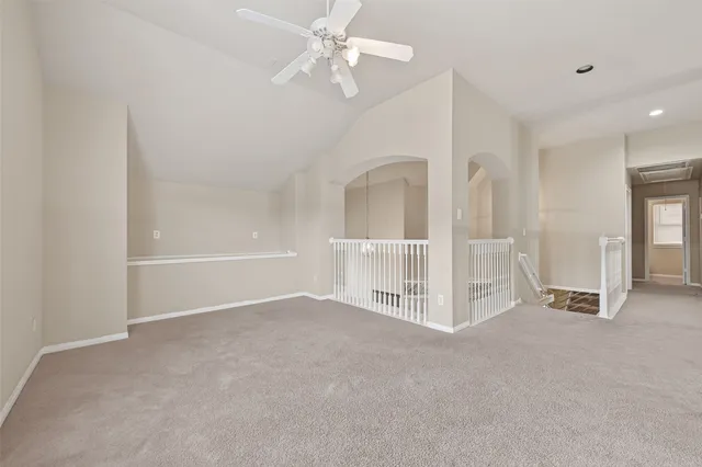 a view of a livingroom with a ceiling fan and window