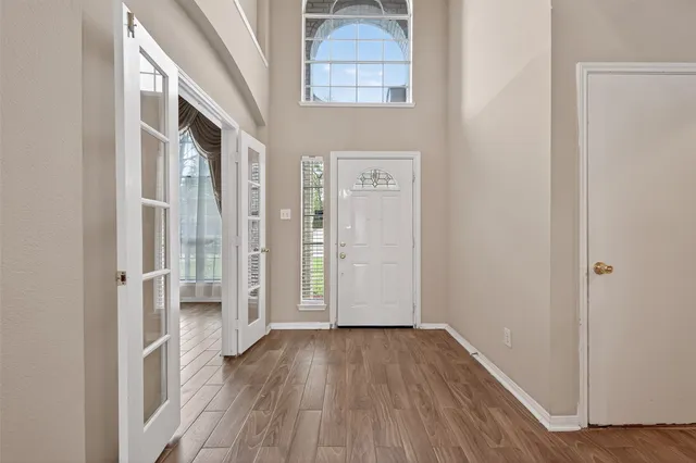 a view of a hallway with wooden floor and closet