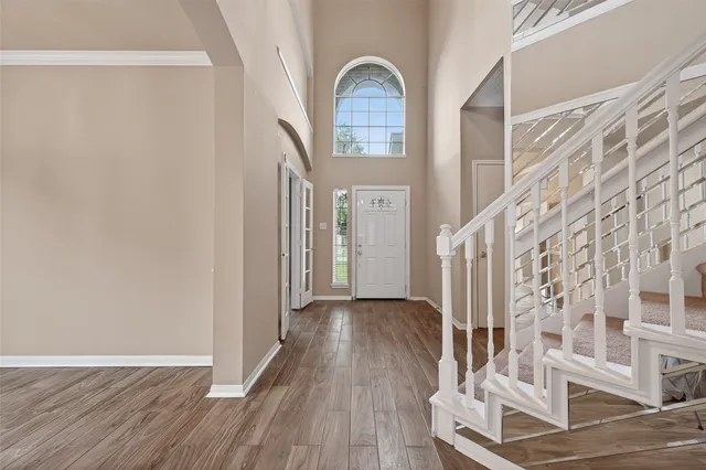 a view of a livingroom with wooden floor and entrance