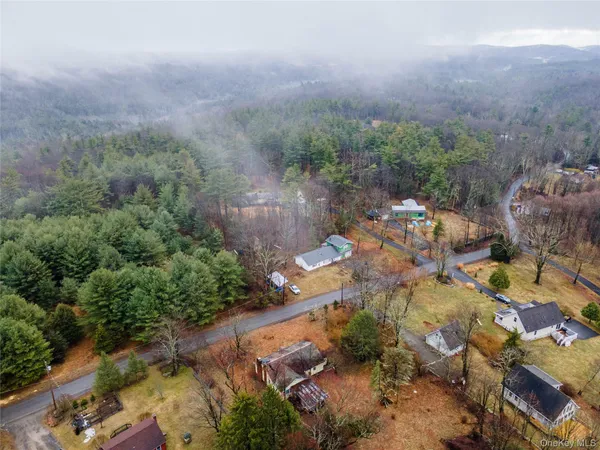 an aerial view of a house with a yard