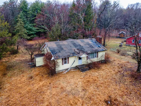 an aerial view of a house with garden space and sitting area