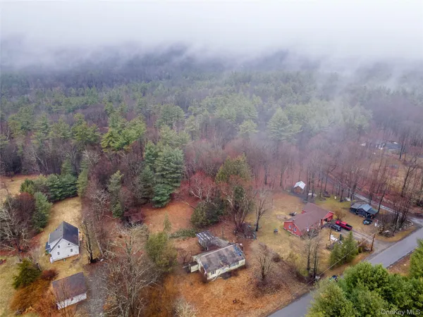 an aerial view of a house with a yard