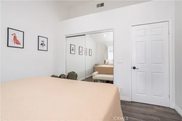 a bedroom with a bed and a painting