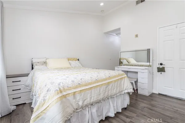 a bedroom with a bed and a dresser