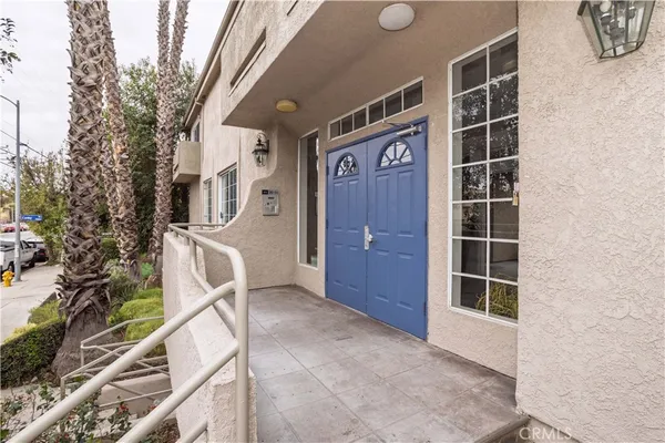 a view of a yard with plants and wooden fence