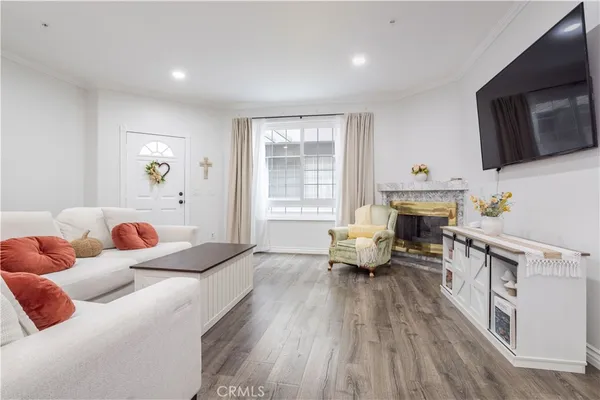 a bedroom with furniture a fireplace and a flat screen tv