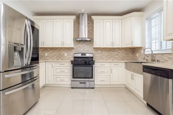 a kitchen with cabinets stainless steel appliances and window