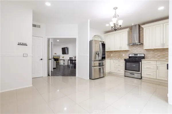 a kitchen with stainless steel appliances a refrigerator sink and cabinets