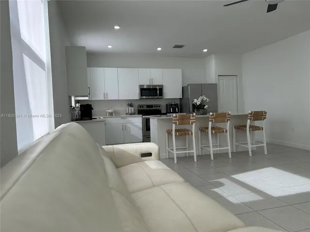 a kitchen with a refrigerator and a stove top oven
