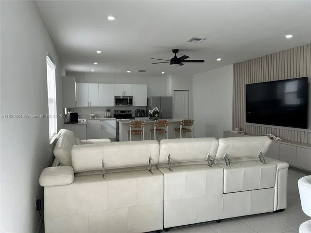 a kitchen with stainless steel appliances a sink a stove a microwave and cabinets