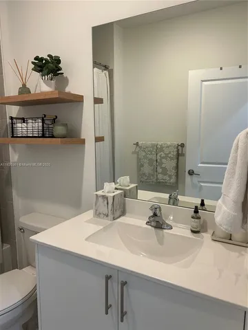 a bathroom with a double vanity sink mirror and shower
