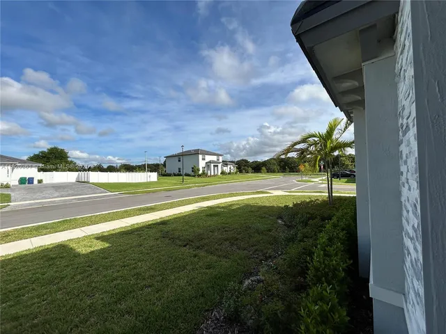 a front view of a house with outdoor seating and plants