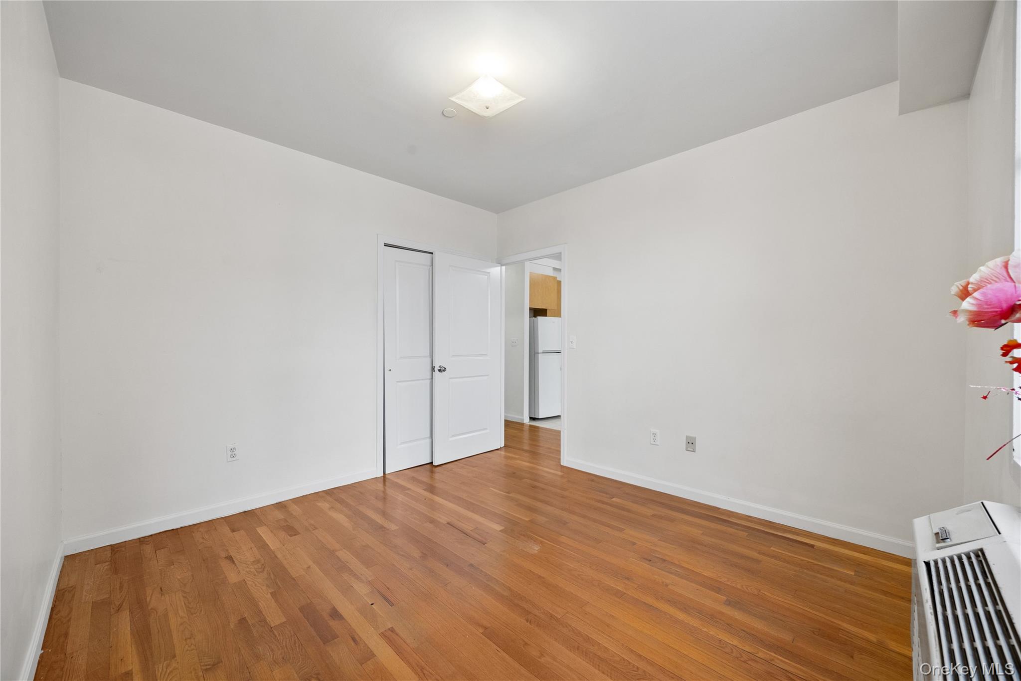 134-38 35th Avenue, Unit 3D Queens, NY 11354 - Photo 11 of 18 a view of empty room with wooden floor