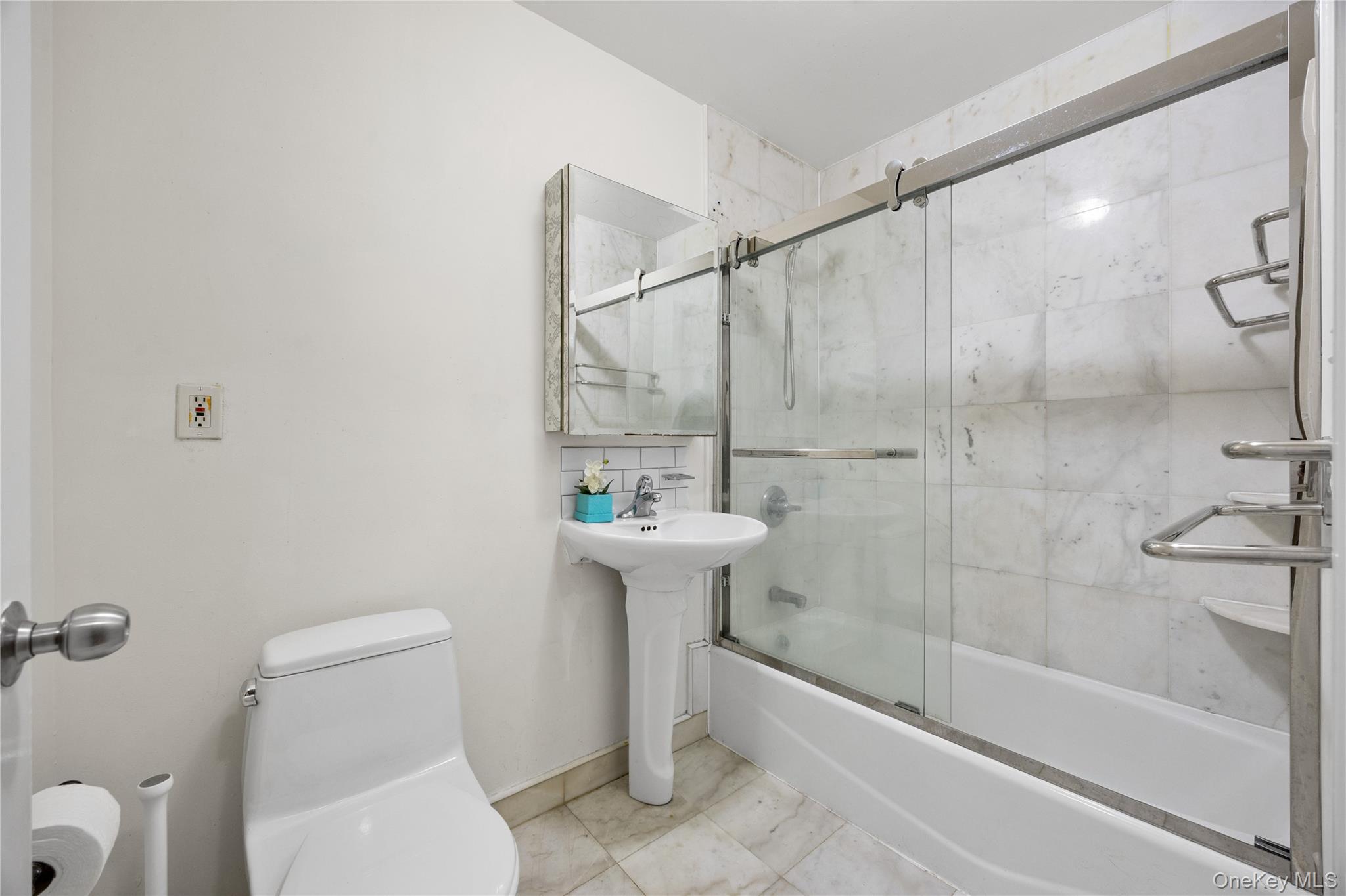 134-38 35th Avenue, Unit 3D Queens, NY 11354 - Photo 13 of 18 a bathroom with a sink toilet and shower