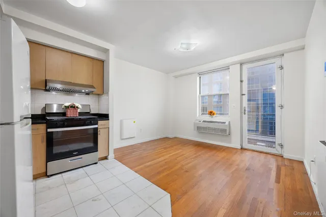 a kitchen with granite countertop a stove and a wooden cabinets