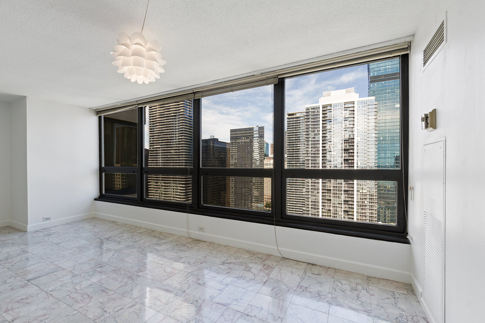 360 East Randolph Street, Unit 3105 Chicago, IL 60601 - Photo 9 of 28 a view of an empty room with a window