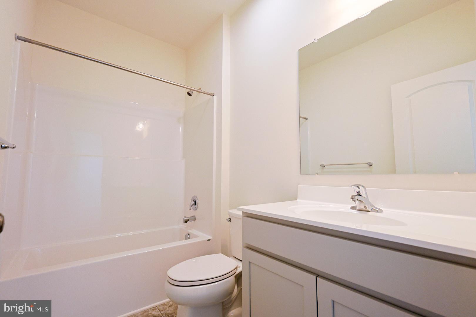 910 Weatherstone Lane Felton, DE 19943 - Photo 19 of 22 a bathroom with a sink toilet and shower