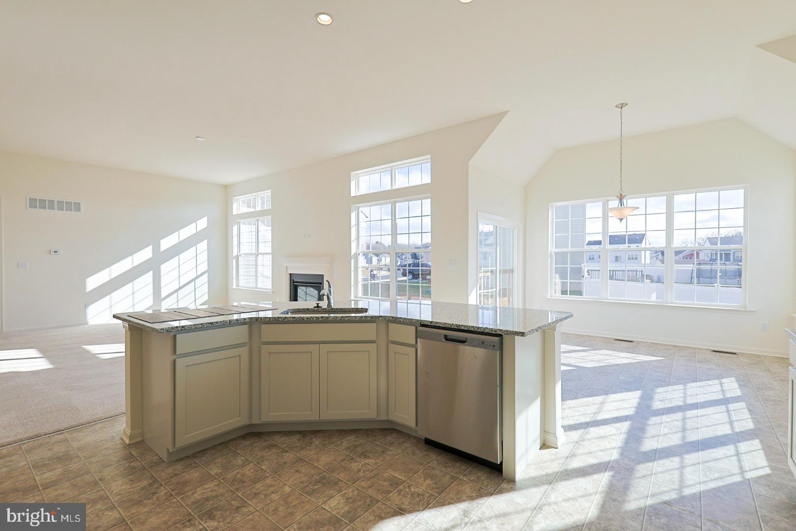 910 Weatherstone Lane Felton, DE 19943 - Photo 7 of 22 a kitchen with stainless steel appliances granite countertop a sink and stove