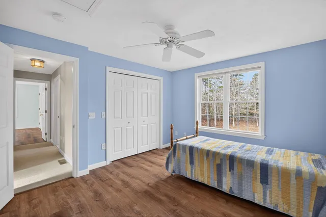 a living room with a bed and a chandelier