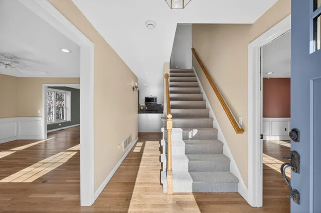 a view of staircase with lots of frames and wooden floor