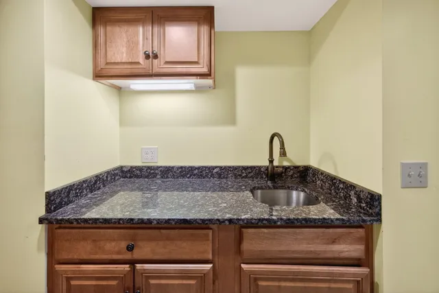 a view of a sink a mirror and cabinets