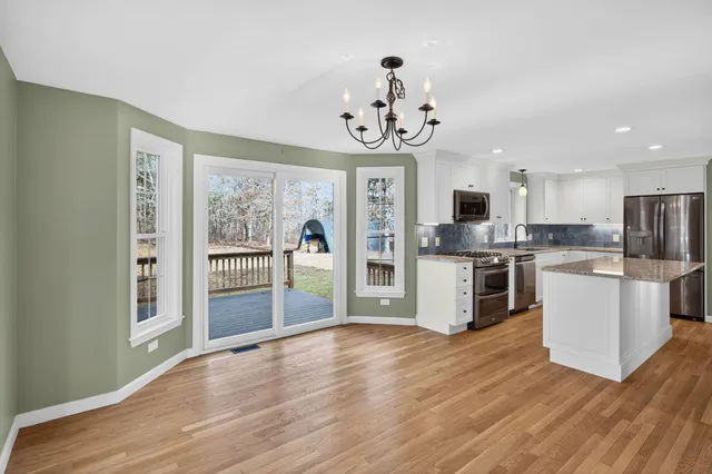 a kitchen with a refrigerator and a stove top oven