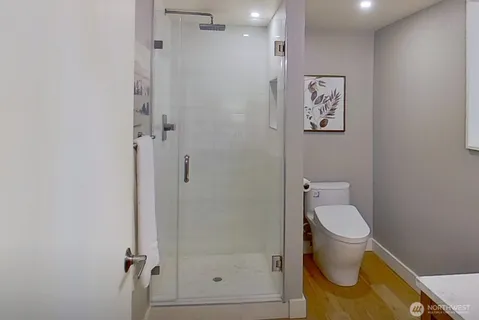 a bathroom with a toilet and a shower