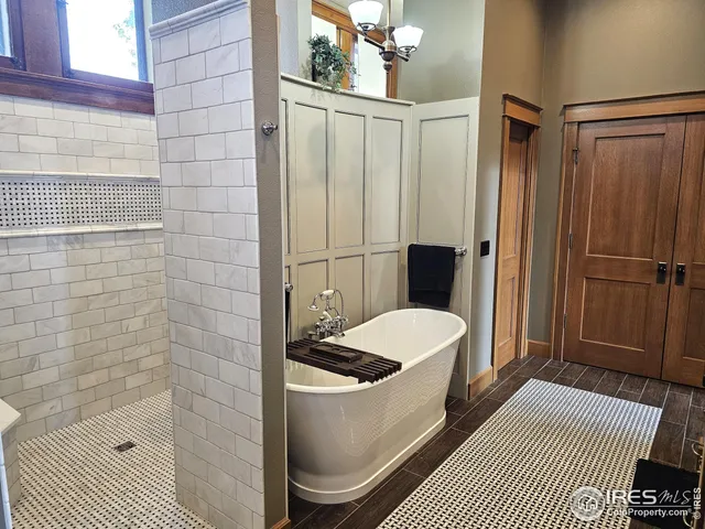 a bedroom with furniture and a chandelier