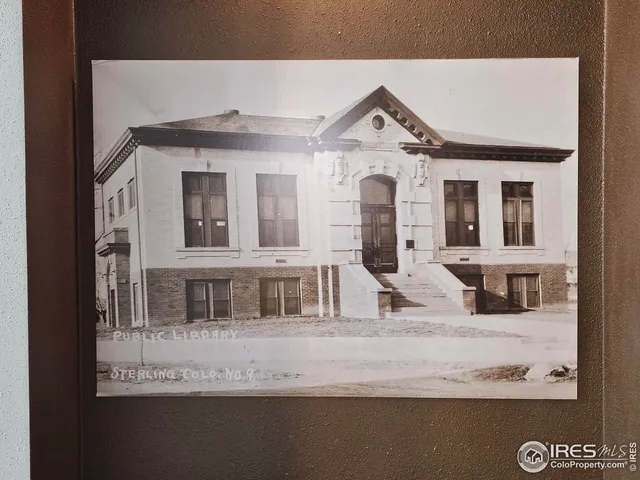 a view of a brick house with large windows