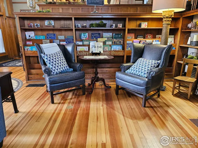 a living room with furniture fireplace and a window