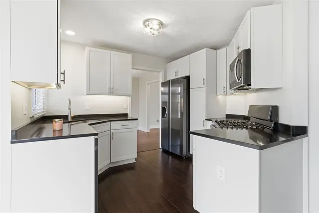 a bathroom with a sink a mirror and a window
