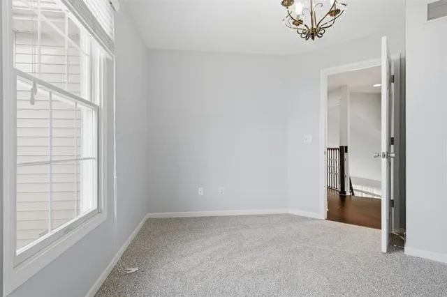a view of a livingroom with a ceiling fan and window