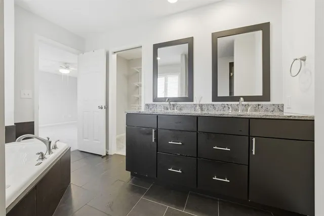 a view of a livingroom with wooden floor and furniture