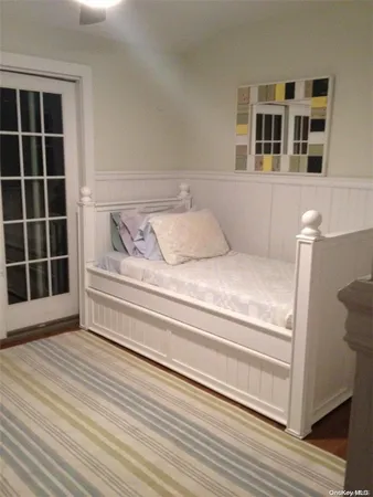 a view of bedroom with wooden floor and windows