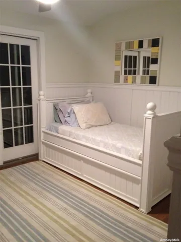 a view of bedroom with wooden floor and windows