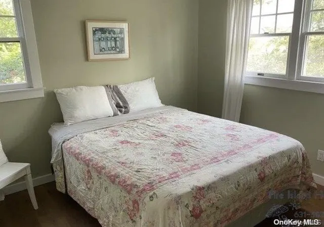 a large bed sitting in a bedroom next to a window