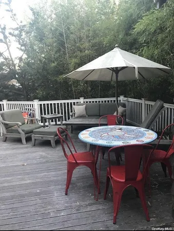 a view of a chairs and table on the deck