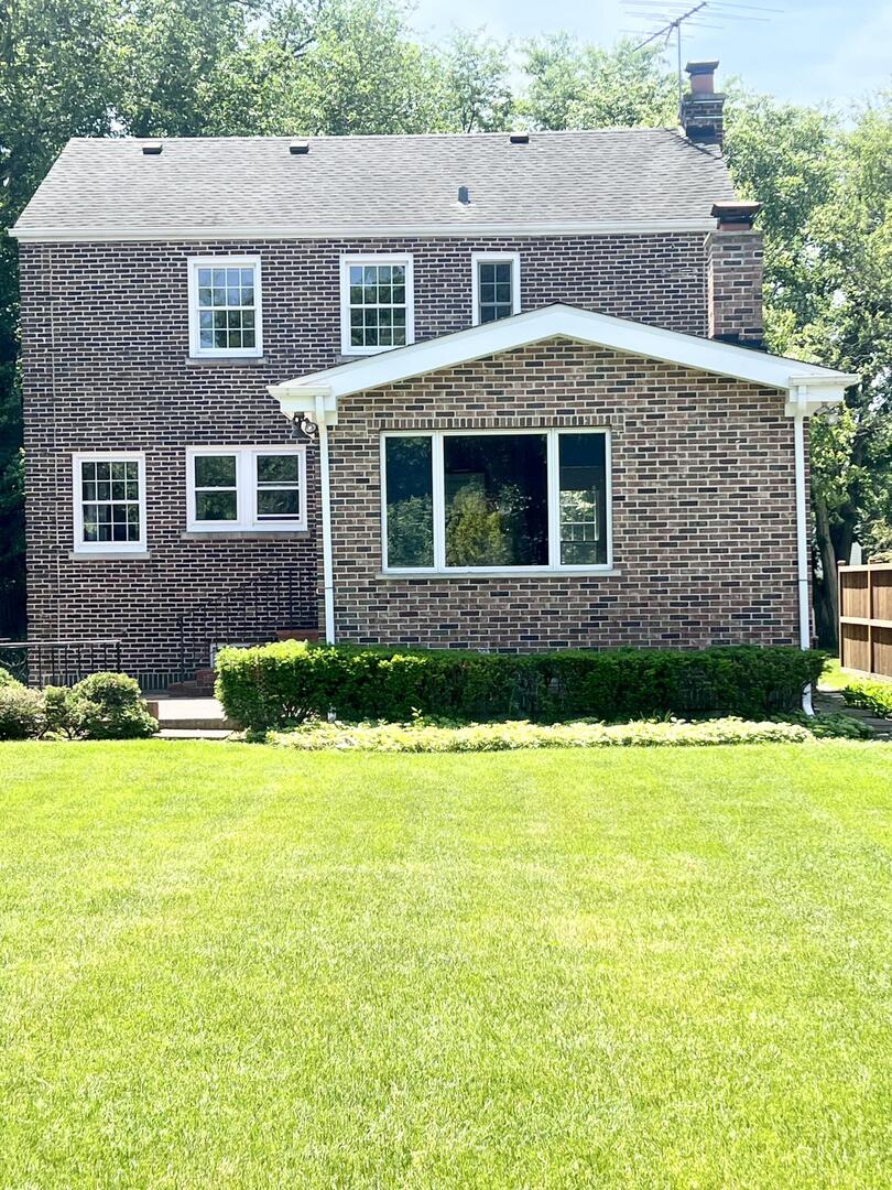 1253 Cherry Street Winnetka, IL 60093 - Photo 2 of 11 a front view of a house with a yard