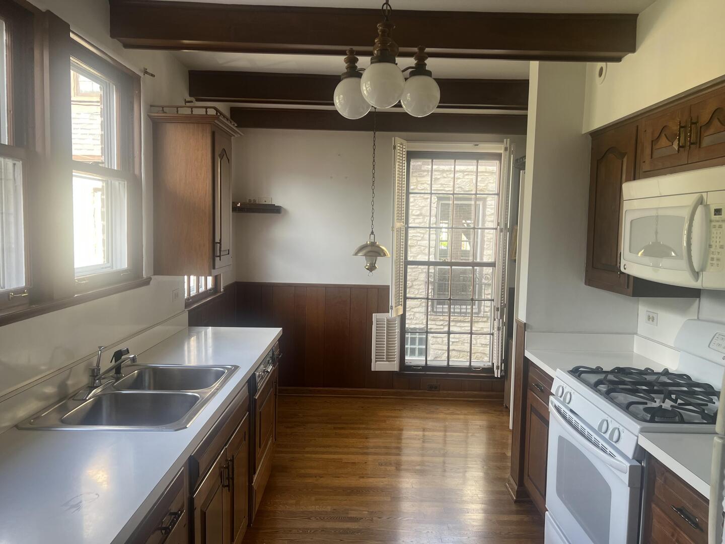 1253 Cherry Street Winnetka, IL 60093 - Photo 7 of 11 a kitchen with granite countertop a sink stainless steel appliances and cabinets