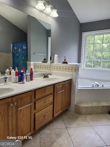 a bath tub sitting in a bathroom next to a window