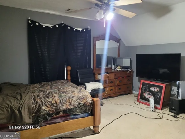 a bathroom with a sink vanity mirror and toilet