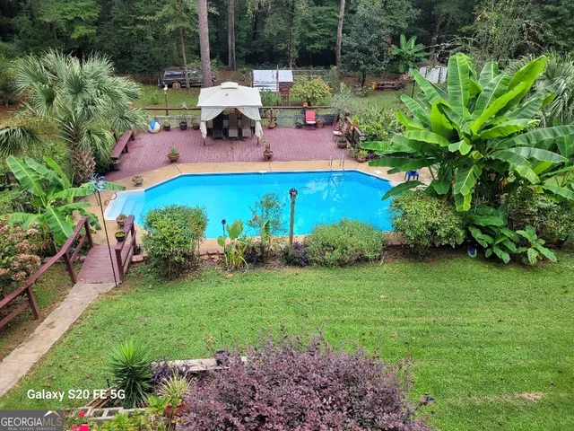 a view of a swimming pool with an outdoor seating