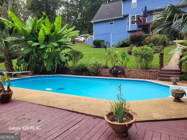 a view of a roof deck with table and chairs under an umbrella