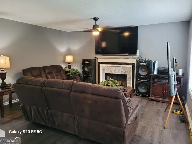 a living room with furniture a fireplace and a flat screen tv
