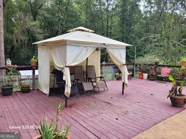 a view of a house with a yard and sitting area