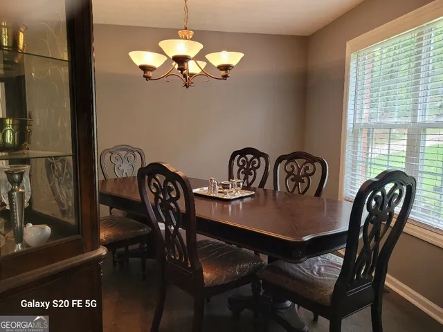 a view of a dining room with furniture window and outside view