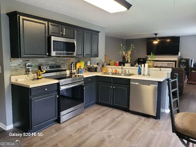 a kitchen with a sink stove and microwave